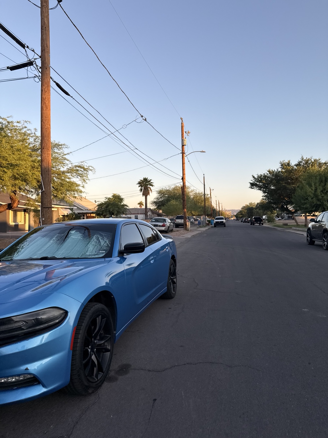 Blue sports sedan on a neighborhood street
