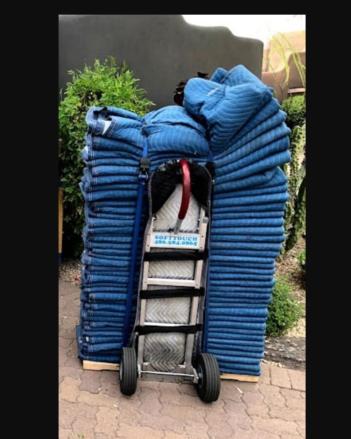 Moving blankets and equipment neatly secured on a dolly
