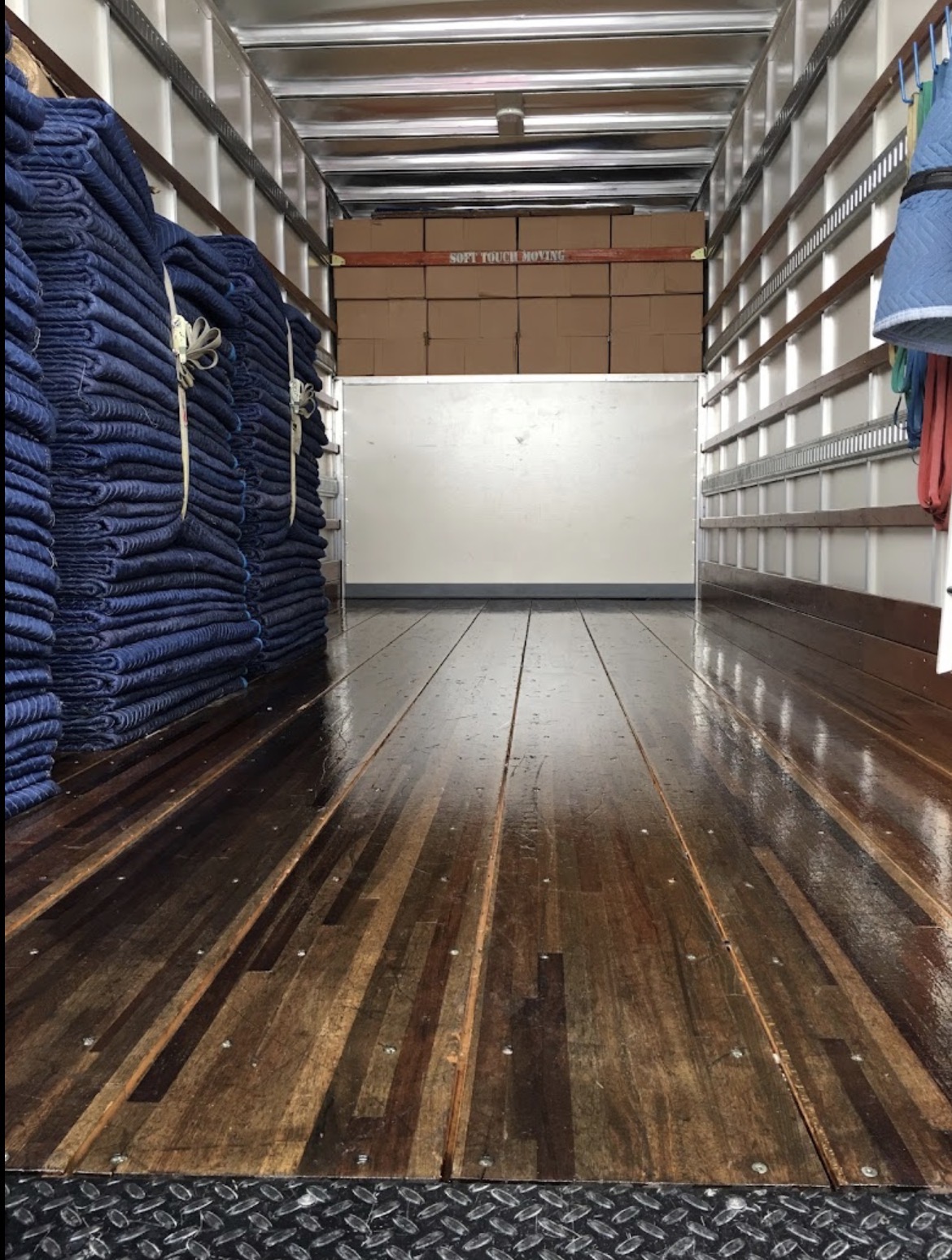 Clean Soft Touch moving truck with organized blankets and packed boxes